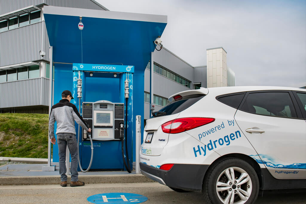 Person fueling a vehicle at a hydrogen fueling station designed and fabricated by Powertech Labs of Surrey.